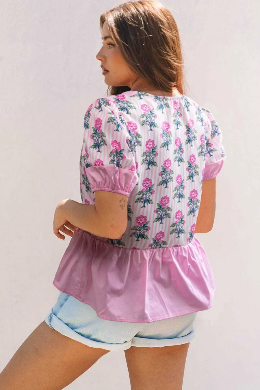 Back view of Rose Floral Patchwork V-Neck Peplum Blouse showing short sleeve and peplum construction — Fashionfitz