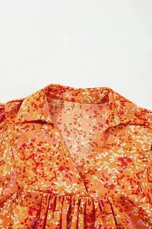Close-up of Abstract Print V-Neck Babydoll Blouse showing vibrant orange abstract print detail — Fashionfitz