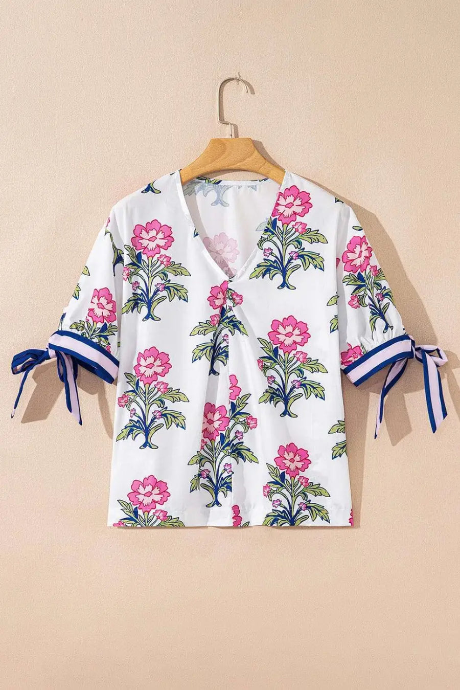 Close-up of White Floral Bubble Sleeve V-Neck Summer Blouse showing vibrant floral print on white 100% polyester and bubble sleeve — Fashionfitz