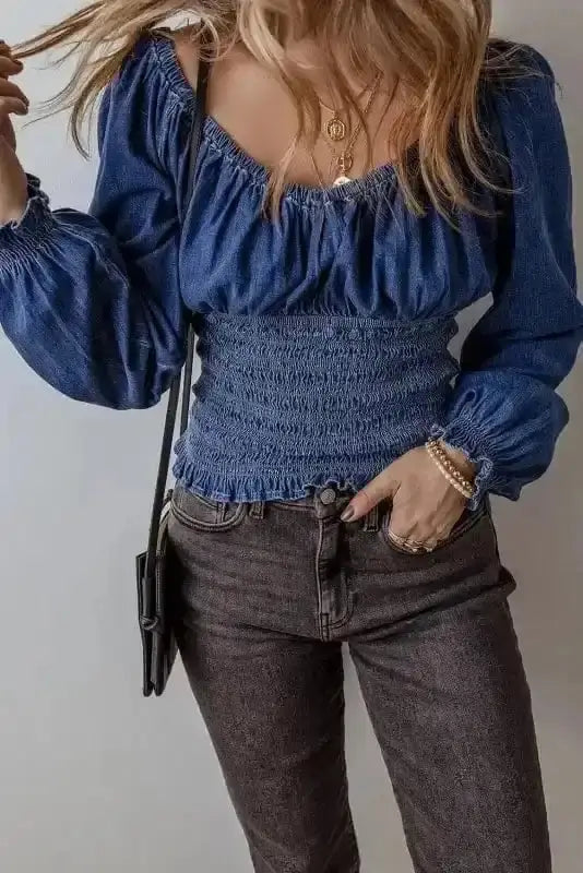 Close-up of Blue Denim Smocked V-Neck Ruffle Sleeve Blouse showing smocked bodice detail and ruffle sleeve on cotton denim — Fashionfitz