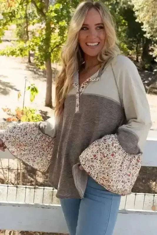 Side view of Floral Patchwork Henley Flared Sleeve Top showing flared sleeve movement and 50% viscose fabric drape — Fashionfitz