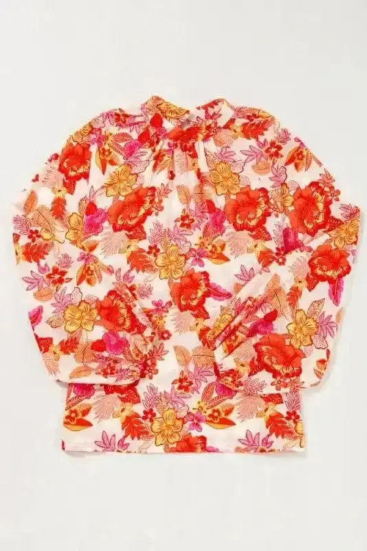 Side view of Orange Floral Pearl Button Mock Neck Blouse showing split V-neckline and ruffled detail — Fashionfitz