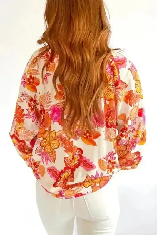 Back view of Orange Floral Pearl Button Mock Neck Blouse showing long sleeve silhouette and fluid 81% viscose drape — Fashionfitz