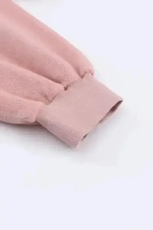 Detail of ribbed cuff on pink women's zip up hooded jacket. Elastic sleeve design for added warmth and comfort in fall and winter.