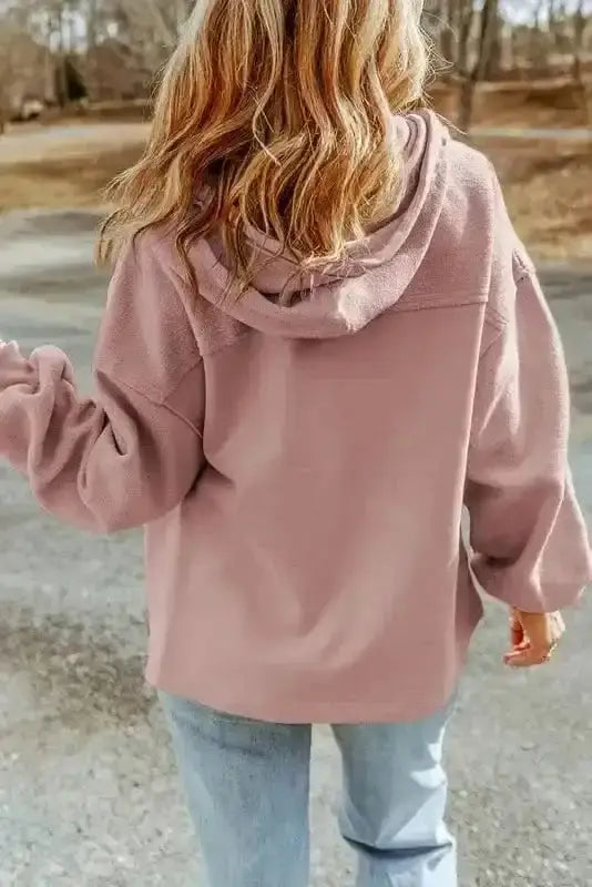 Back view of pink zip up hooded jacket for women featuring relaxed fit and cozy fleece texture. Ideal for casual fall and winter layering.