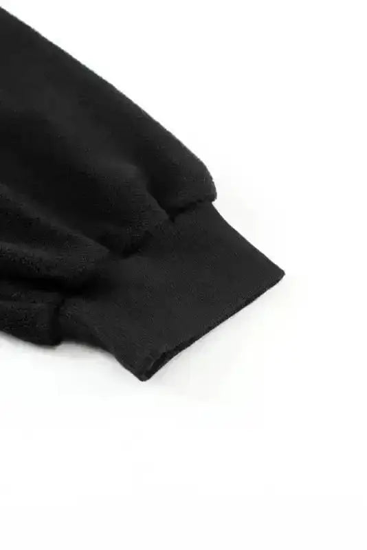 Detail of ribbed cuff on black zip up hooded jacket for women, highlighting the snug and warm sleeve design.