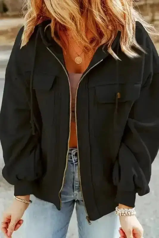 Front view of black zip up hooded jacket women with button flap pockets and drawstring hood. Soft fleece outerwear for daily wear.