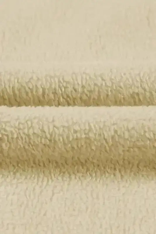 Textured fleece fabric close-up of beige zip up hooded jacket women. Soft and warm material for fall and winter.