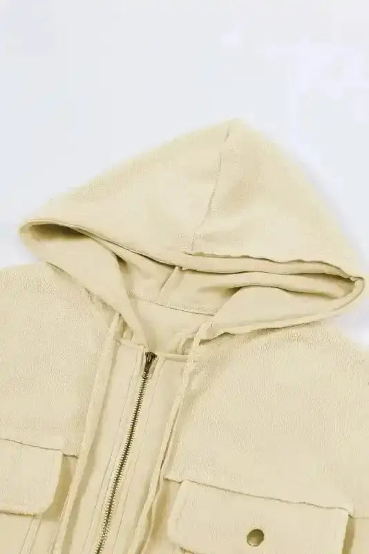 Drawstring hood detail of beige zip up hooded jacket women. Cozy fleece hood for added warmth.