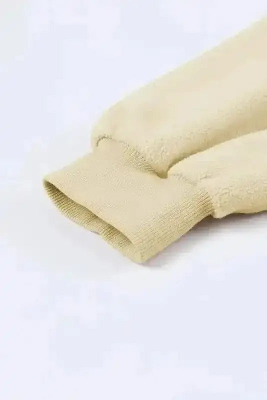 Sleeve cuff detail of beige zip up hooded jacket women. Ribbed knit finish for snug fit and warmth.
