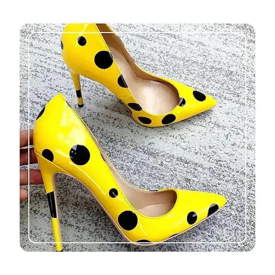 Top view of Polka Dot Yellow Stiletto High Heels Shoes laid on floor, showing full polka dot pattern. Trendy pumps for stylish ensembles.