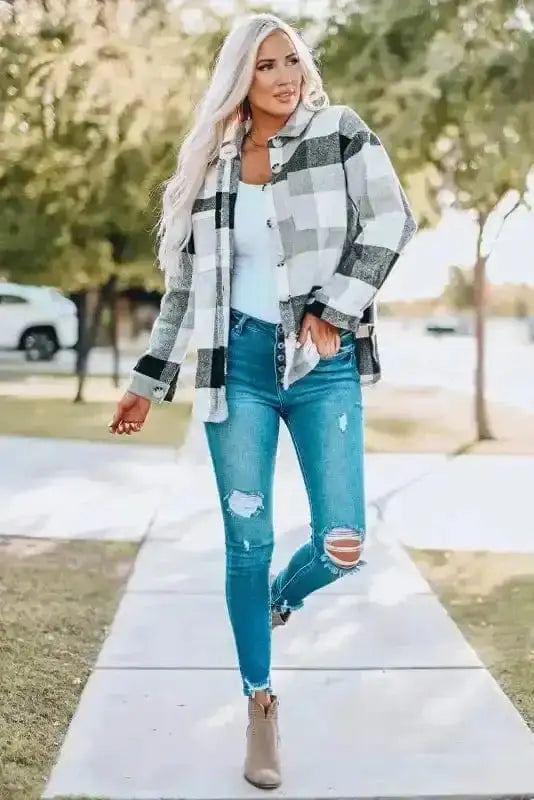 Woman wearing gray plaid color block jacket with ripped jeans and ankle boots, perfect for casual fall fashion.
