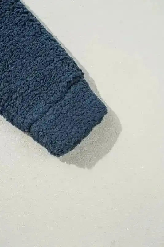 Sleeve cuff detail of the cozy blue teddy coat, highlighting the thick fleece fabric and comfortable fit for cold days.