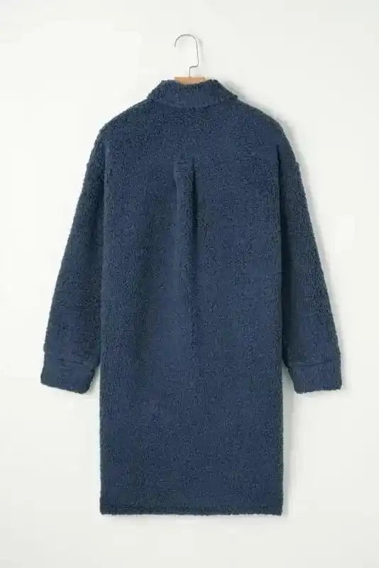 Back view of the blue teddy coat on hanger, showcasing its longline cut and plush fleece texture for winter comfort.