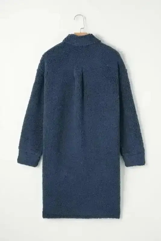 Back view of the blue teddy coat on hanger, showcasing its longline cut and plush fleece texture for winter comfort.