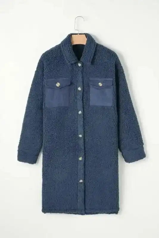 Full front view of the blue teddy coat on hanger, featuring soft fleece fabric, button closure, and contrast chest pockets.