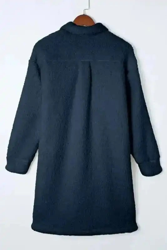 Rear flat view of the blue teddy coat showing its plush fleece texture and longline silhouette, ideal for cold weather.