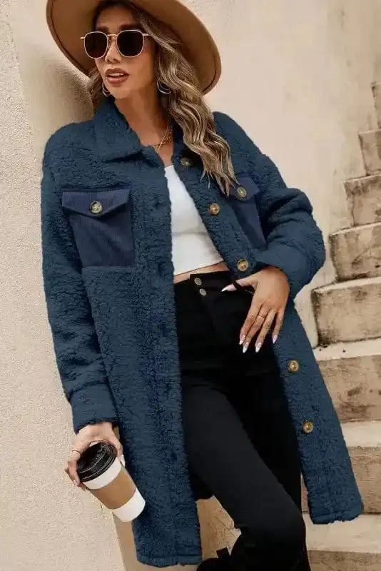 Model wearing cozy blue teddy coat with front button closure and navy chest pockets, styled for a trendy winter outfit.