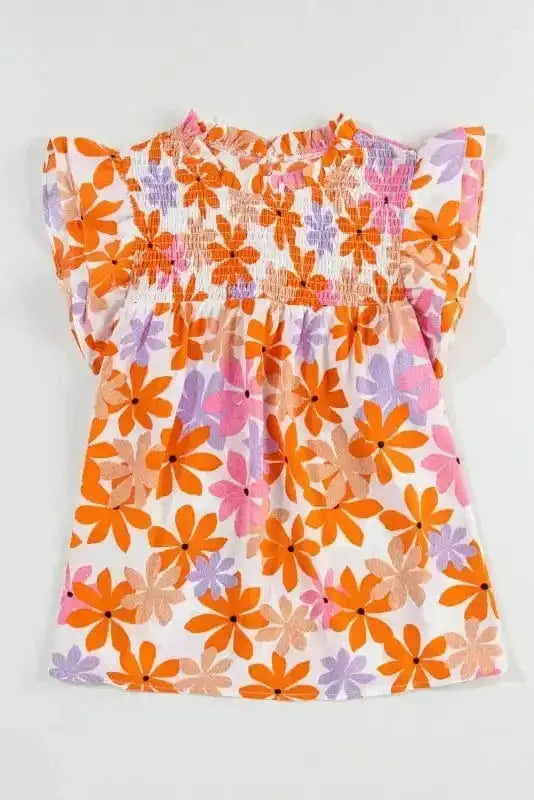 Flat lay of Orange Smocked Floral Top with ruffled short sleeves and colorful floral print. Blouse from FashionFitz Apparel Collection.