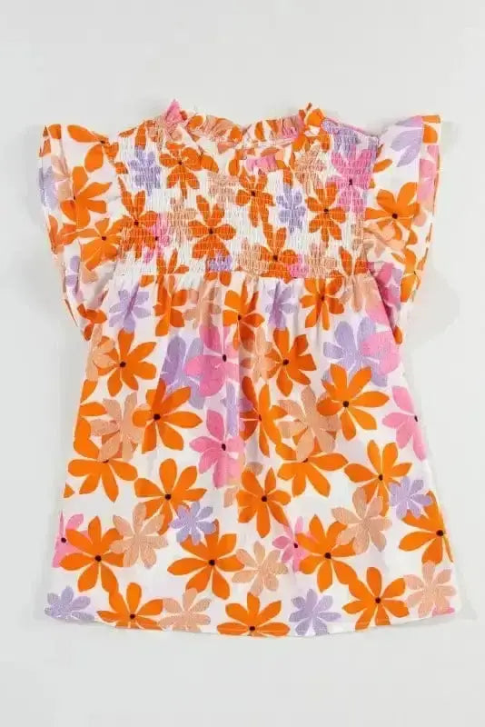 Flat lay of Orange Smocked Floral Top with ruffled short sleeves and colorful floral print. Blouse from FashionFitz Apparel Collection.