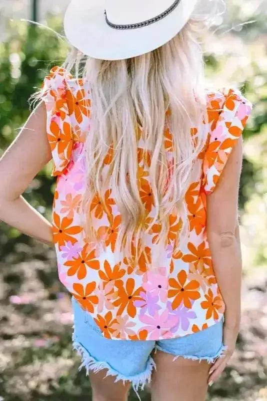 Back view of the Orange Smocked Floral Top showing ruffled sleeves and vibrant floral print. Ideal for casual summer wear.