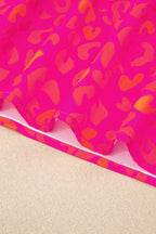 Close-up of puff sleeves and round neckline on a pink leopard print top.