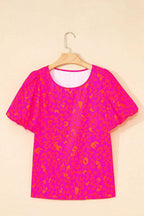 Pink leopard print puff sleeve top displayed on a hanger against a white background.