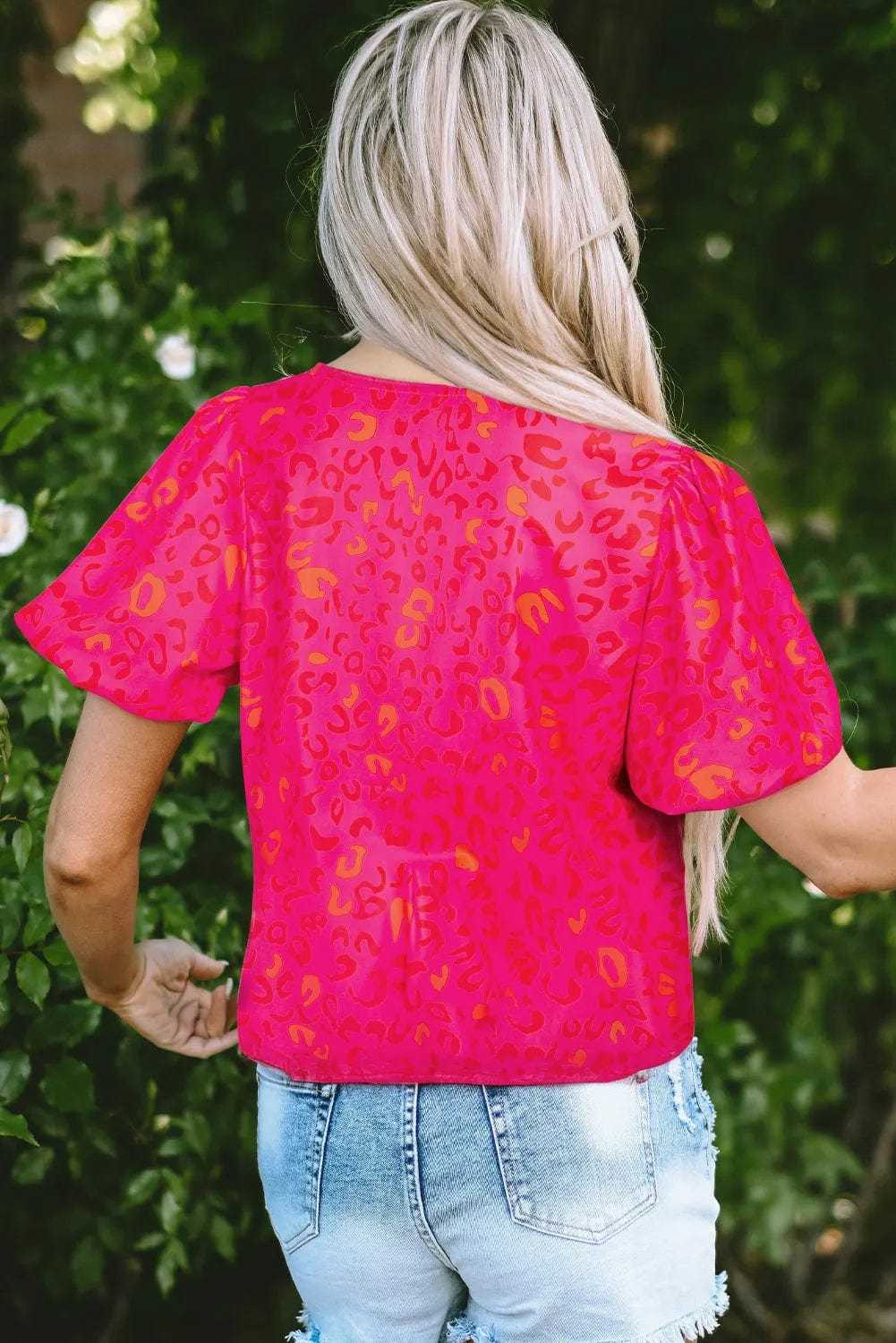 Back view of the pink leopard print puff sleeve top showing fabric texture and fit.