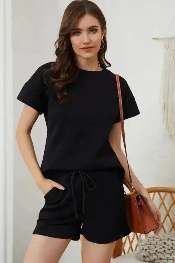 Flat lay of black ribbed two piece shorts outfit showing matching top and pocketed drawstring shorts Fashionfitz UK