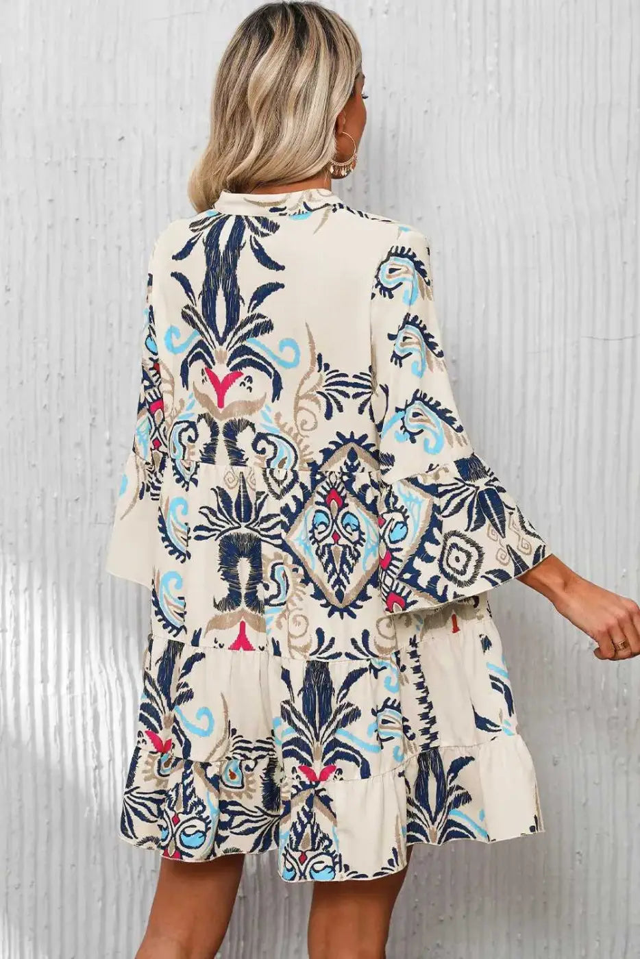 Back view of the Tribal Mini Dress on model, highlighting the flared bracelet sleeves and colorful tribal print.