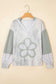 Gray sweater with floral patterns on a beige background