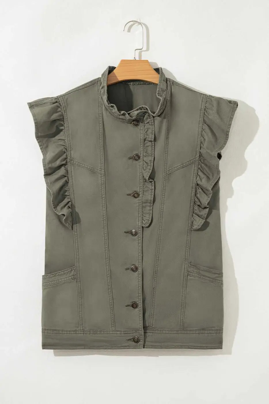 Flat lay of Green Bay Ruffled Denim Vest - Women's Fashion Trends on hanger, showcasing button-down front and structured denim silhouette.