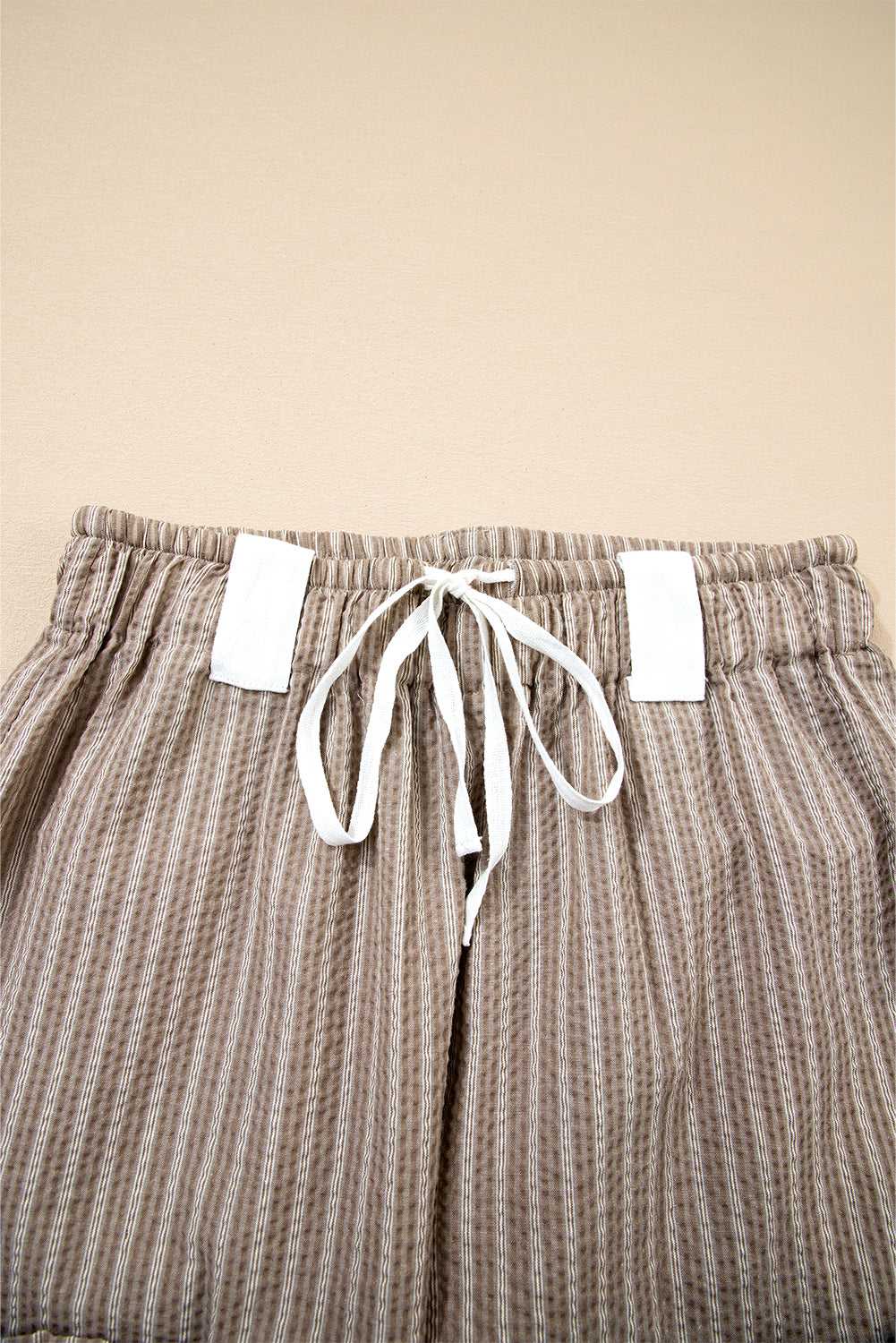 Close-up of drawstring waistband on Women's Brown Stripe Cargo Joggers, showing white tie and elastic band.