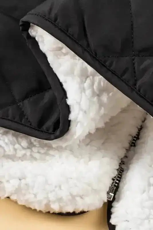 Close-up of white fleece interior and hemline of black Women's Quilted Vest Winter Gilet by FashionFitz, showcasing warm winter fabric.