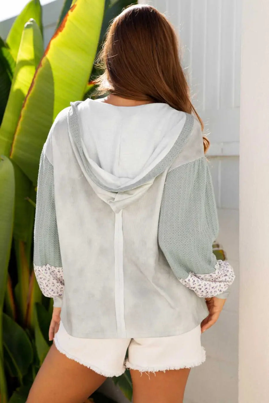 Back view of Floral Applique Oversize Hoodie in pear-green waffle knit with floral cuffs, hooded V-neck and relaxed fit for fall fashion.