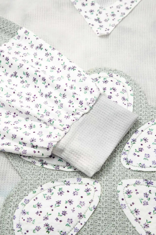 Floral-patterned fabric pieces on a textured surface