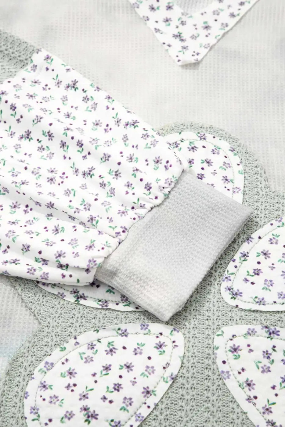 Floral-patterned fabric pieces on a textured surface