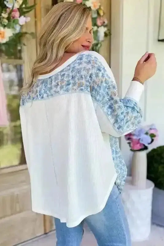 Back view of Abstract Floral Batwing V-Neck Blouse showing dramatic batwing sleeve drape and V-neckline — Fashionfitz