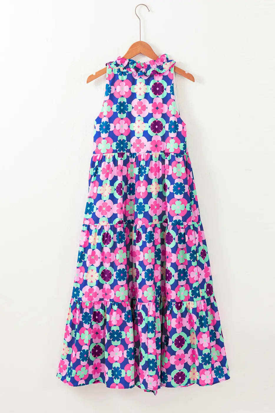 Floral cascade summer dress: colorful floral-patterned maxi dress on a wooden hanger