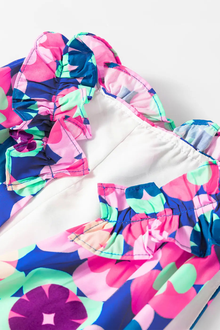 Colorful floral cascade bikini top for a relax relax summer look with ruffled edges