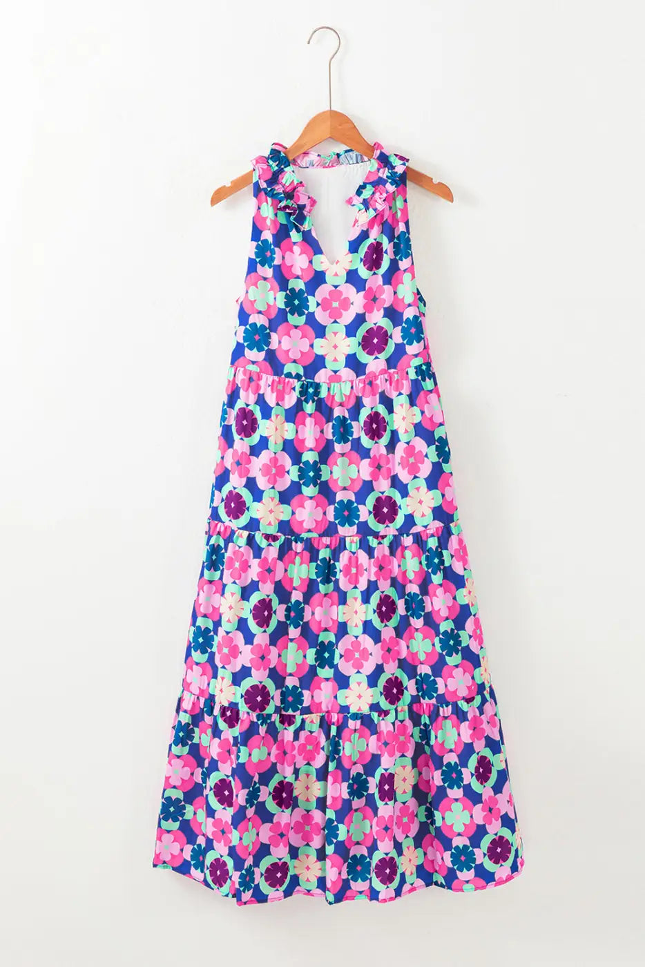 Floral cascade summer dress: colorful floral print maxi dress on a wooden hanger