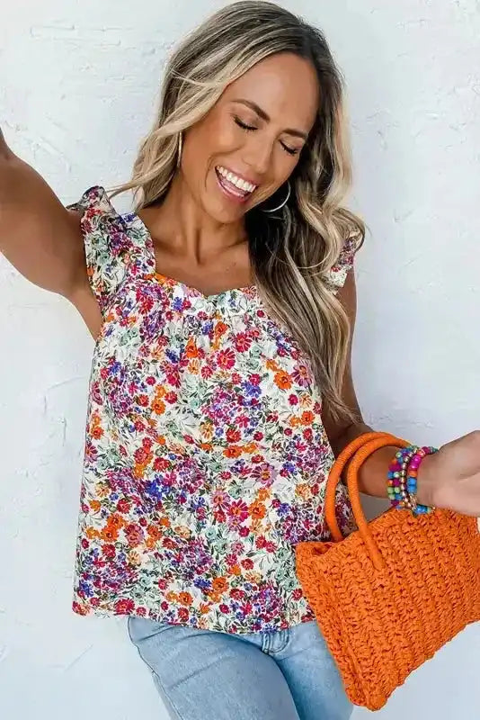 Woman wearing Floral Flutter Tank Top - Square Neck Style with vibrant floral print, styled for casual summer outings.