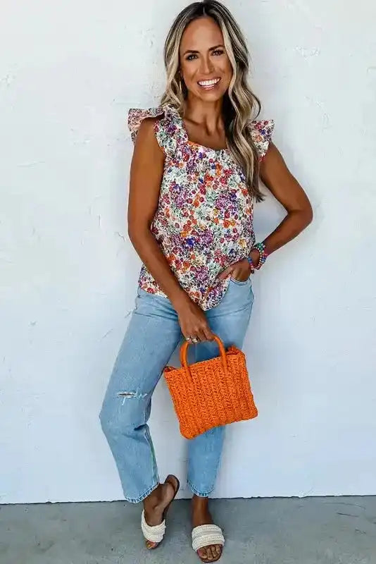 Model styling Floral Flutter Tank Top - Square Neck Style with ripped jeans and woven handbag, ideal for daily casual wear.