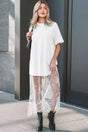 White Floral Lace Skirt Maxi Dress with short sleeves and sheer lace hem, styled with black ankle boots for a chic summer look.