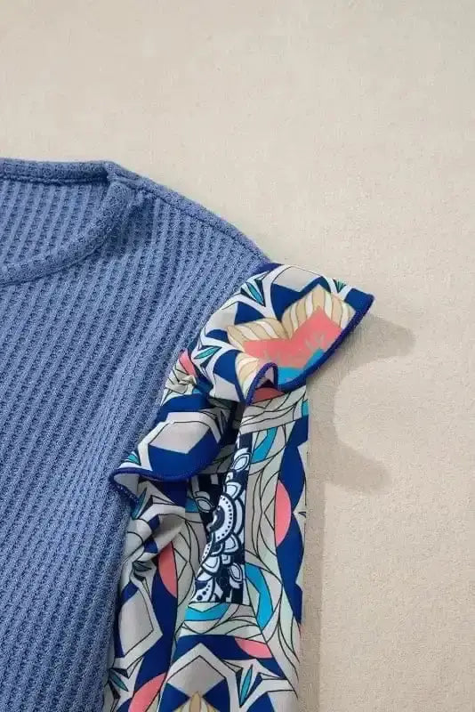 Close-up of Floral Sleeve Waffle Knit Ruffle Blouse showing waffle knit texture in ashleigh blue and contrasting floral sleeve patchwork — Fashionfitz