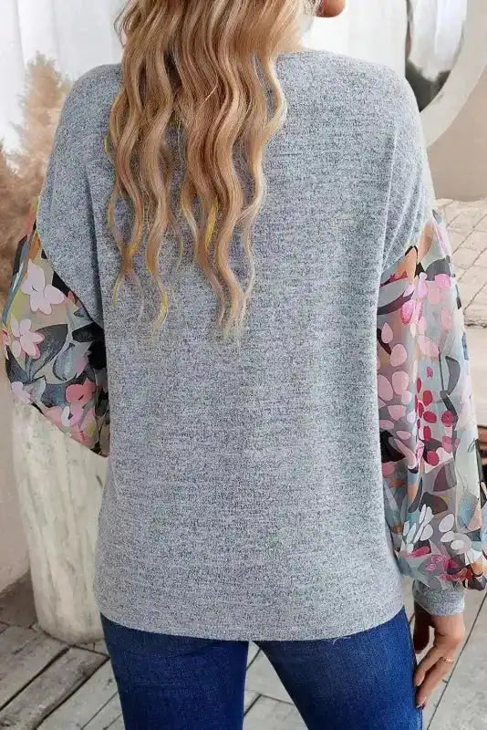 Back view of Gray Floral-Sleeves Buttoned V-Neck Top highlighting soft knit fabric and colorful sheer floral sleeves.