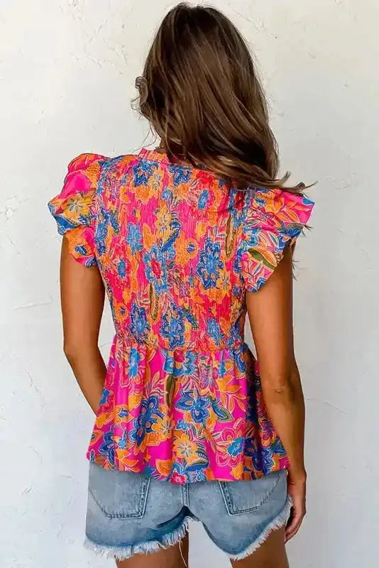 Back view of Floral Smocked Ruffle Trim Blouse showing flared silhouette and flutter cap sleeves — Fashionfitz