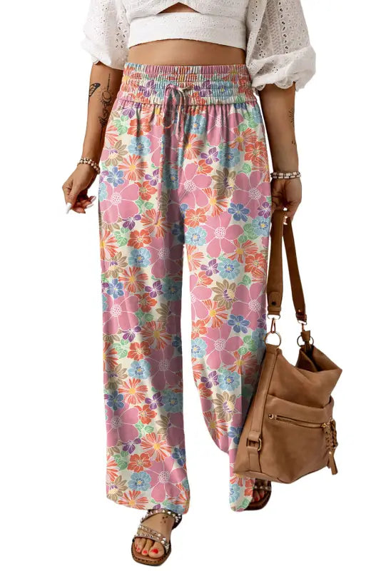 Colorful floral print wide-leg pants with smocked waist, elastic waistband, and drawstring