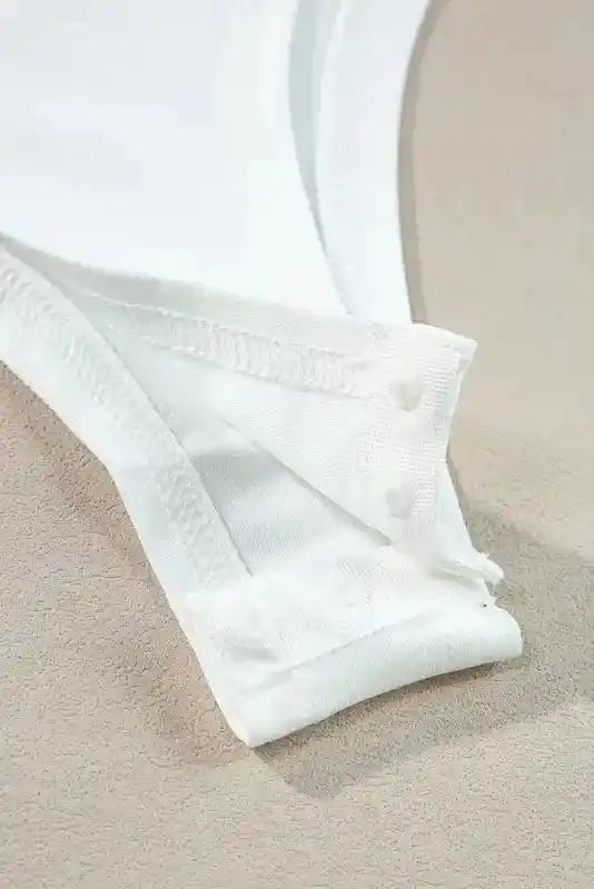Snap button closure detail on white Lace Sleeve Bodysuit, designed for easy wear and a seamless, elegant finish.