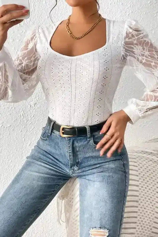 Model wearing Elegant Lace Sleeve Bodysuit in white, paired with high-waisted jeans, showcasing comfort fit and lace sleeve detail.